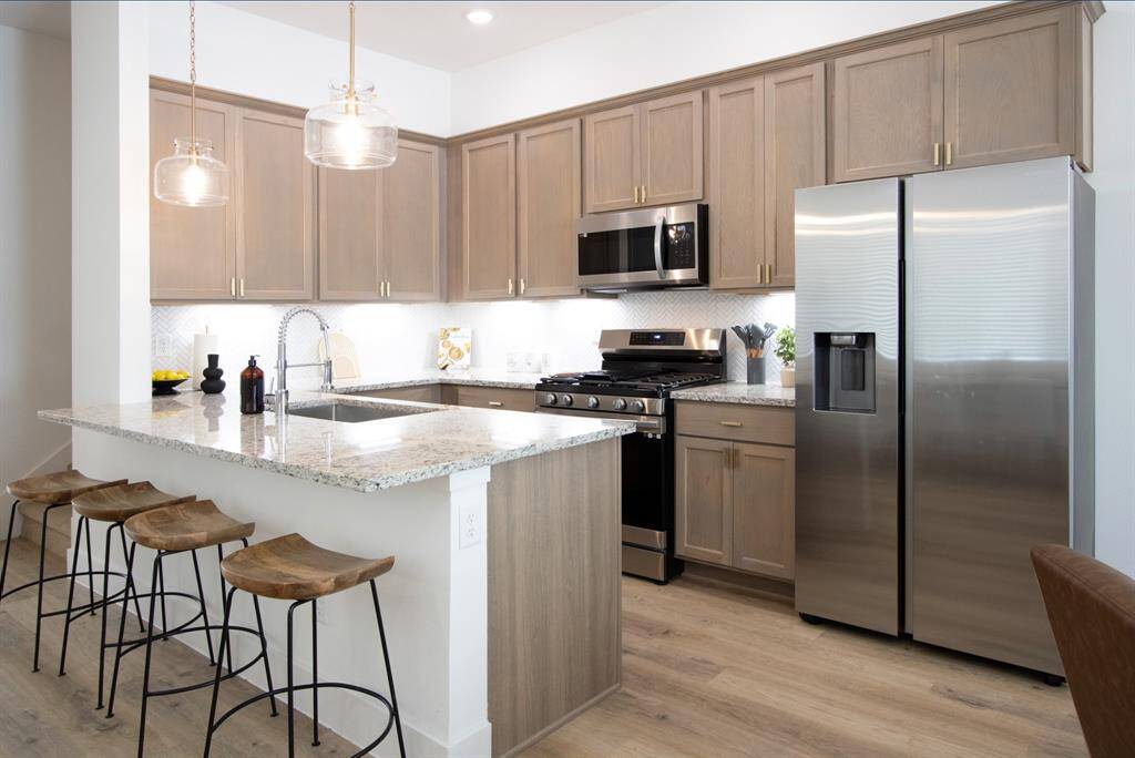 Model Home w/ granite counter top. 1544 has upgraded quartz counters!
