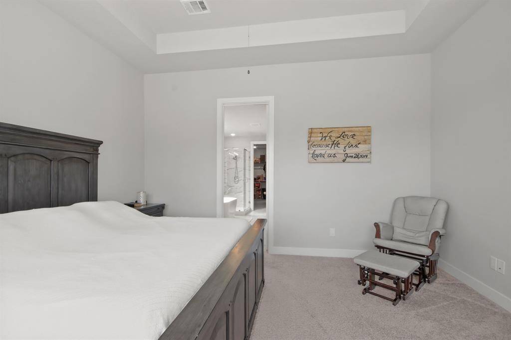 Large primary bedroom with trey ceiling leads to an immaculate primary bathroom.