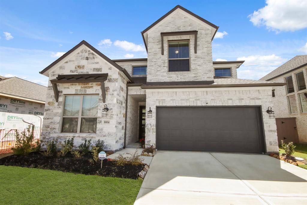 Beautiful wooden custom door and covered entry way. Home is located only three doors down from neighborhood park and green space.