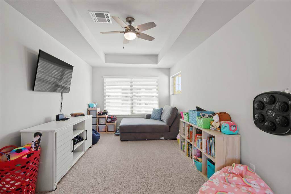 Gameroom is large in size and has a tray ceiling and large window for natural light.