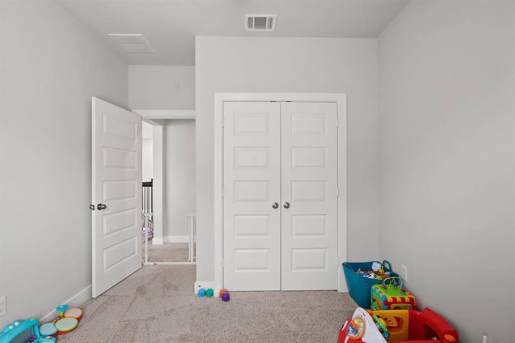 Bedroom leads to hallway and winding staircase.