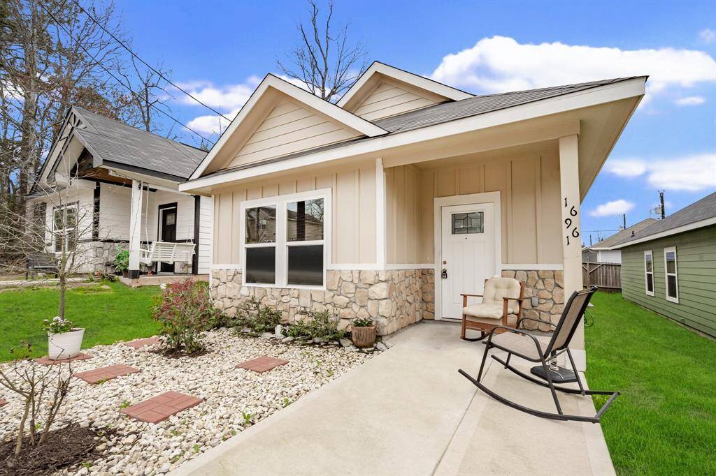 The front of the house features a cute porch. and a rock garden for easy upkeep!