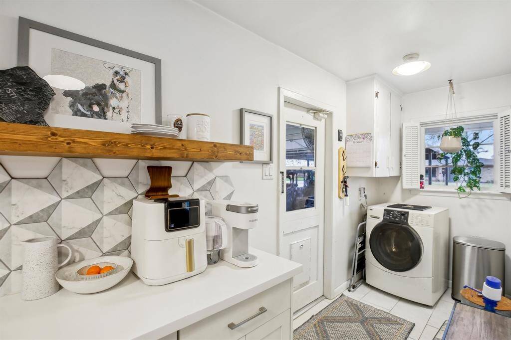 The kitchen opens into a laundry nook with a door leading to the garage.