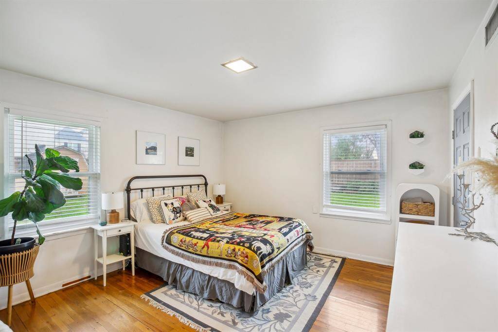 Master bedroom with hardwood floors.