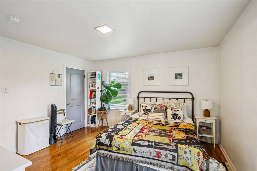 Master bedroom with hardwood floors.