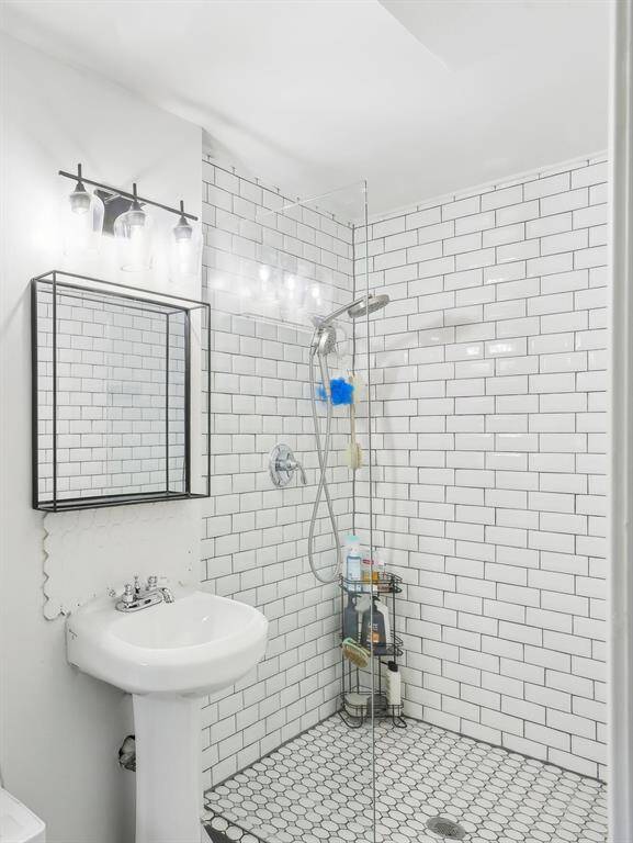 The master bathroom features a modern design with accessible shower.
