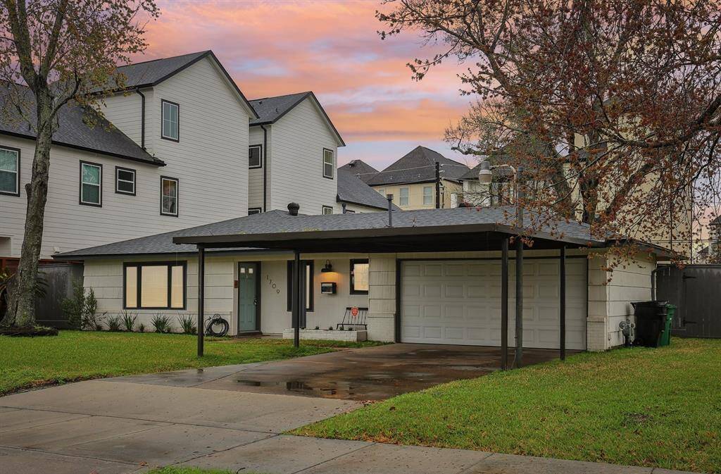 Two-car garage and a covered driveway. The exterior is complemented by well-maintained landscaping.