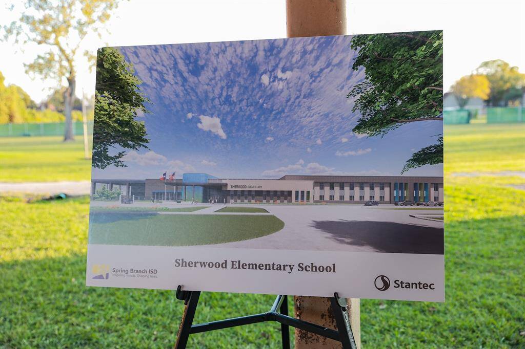 A display board shows a rendering of Sherwood Elementary. Sherwood Elementary is being rebuilt with a bond program and will open in August 2026.