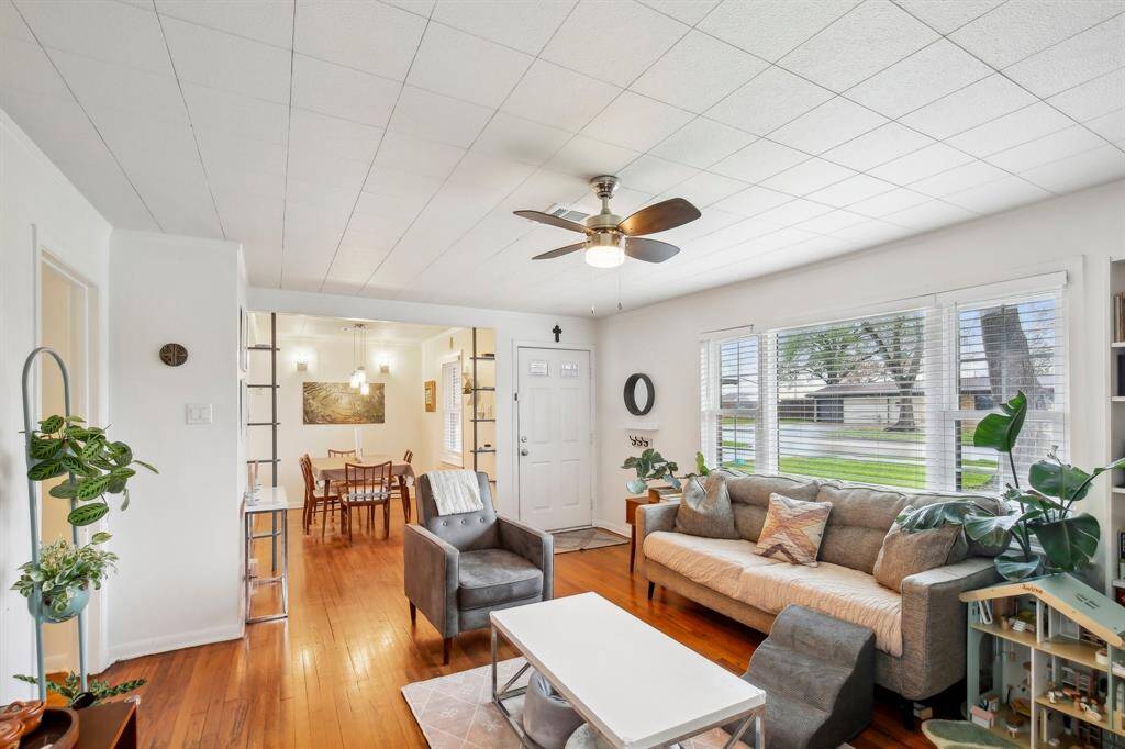 The living room opens to a dining area, creating a seamless flow for entertaining.