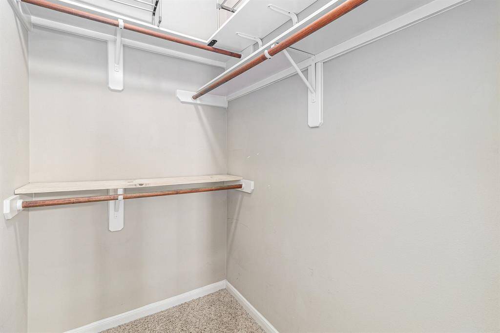 Primary bath with dual split vanities, an oversized tub, walk in shower, and his and hers walk in closets!