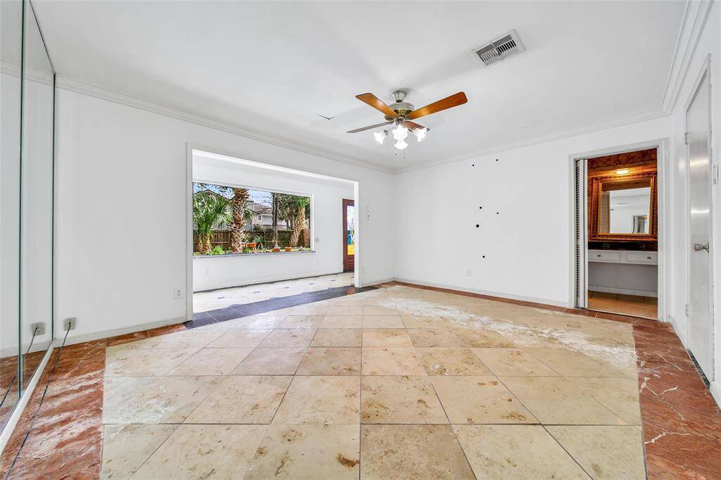 Primary bedroom downstairs. Look at that gorgeous picture window looking out at the expansive backyard!