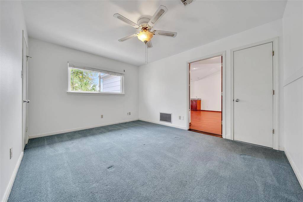 Secondary bedroom upstairs with freshly painted white walls.