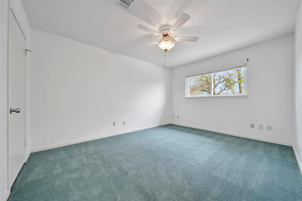 Secondary bedroom upstairs with freshly painted white walls.