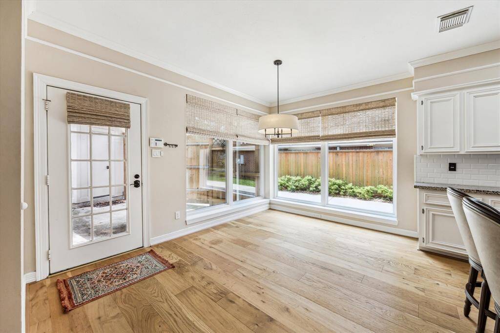 Breakfast area has lots of natural light from windows and the back door leads out onto the back patio.