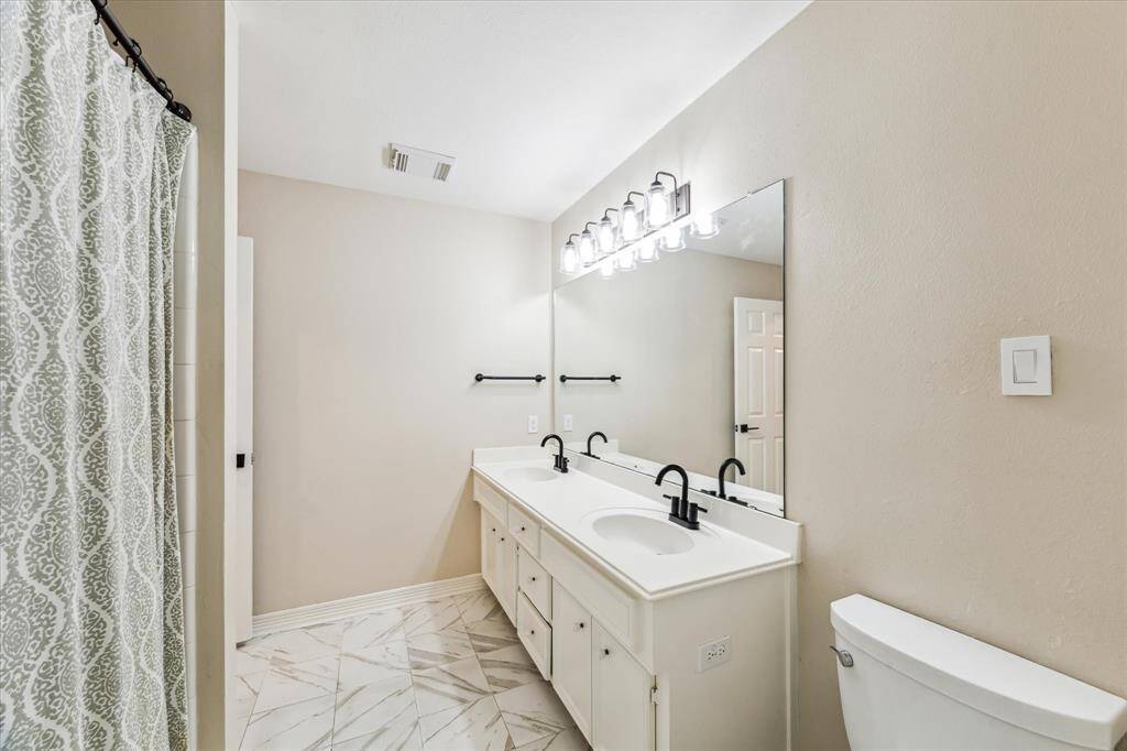 Upper level full bath 3 has an expanded vanity with double sinks and solid surface top.