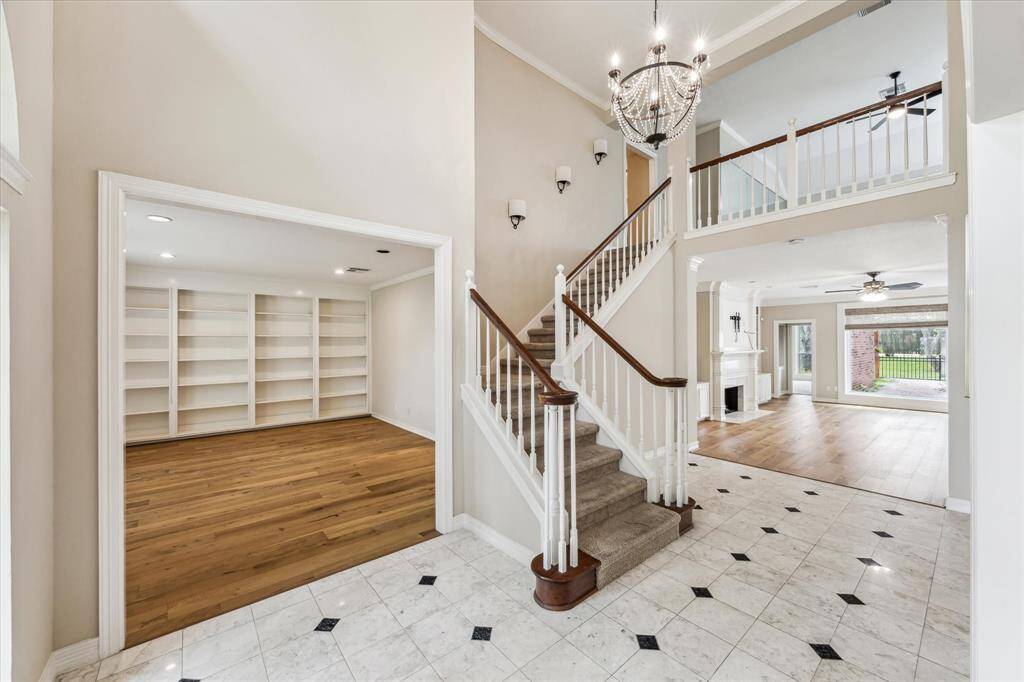 Entrance to the large home office/study is at the left of the entry. The angled staircase leads to upper level gameroom, media room, bedrooms 2-4 and bathrooms 2 and 3.