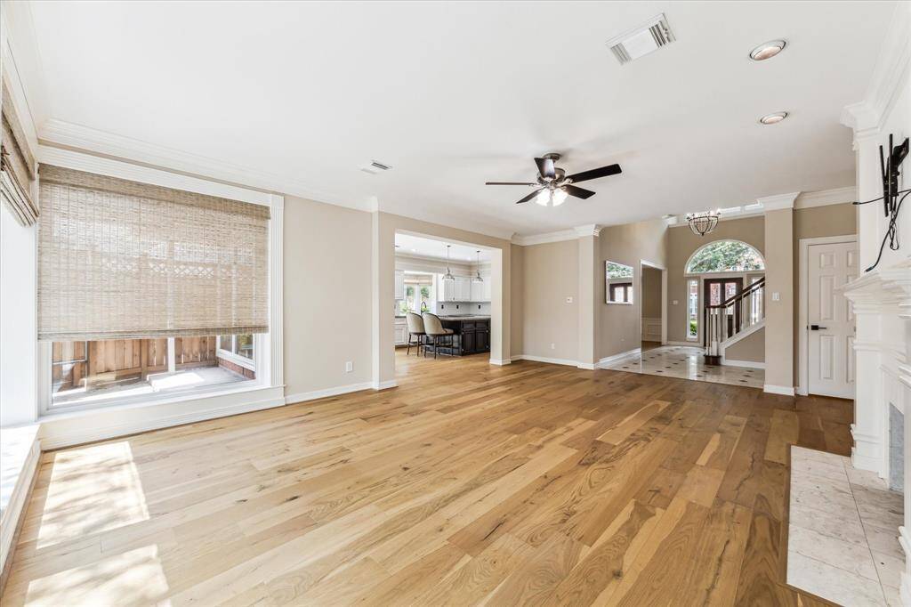 This is a view from the rear of the family room toward the front entry and the breakfast area and kitchen.