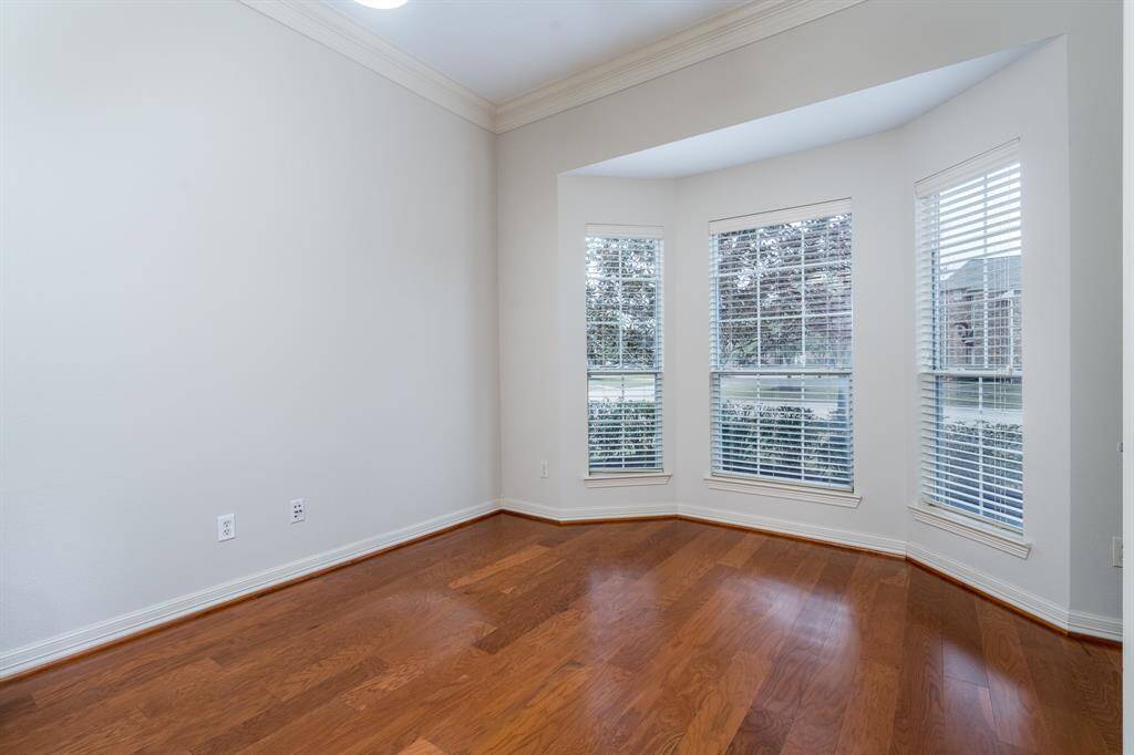 This beautifully designed formal dining room with an elegant and inviting atmosphere. The space features a coffered ceiling with crown molding and a statement chandelier, adding warmth and sophistication.