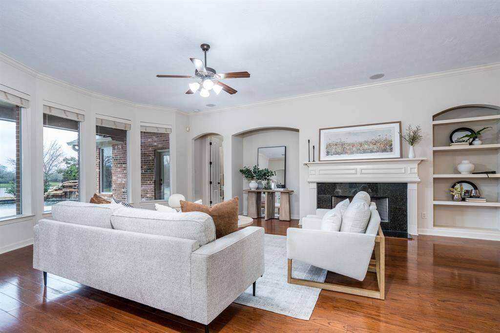 The wood flooring continue into the large home office overlooking the front of the home. Don't miss the large windows and crown molding.