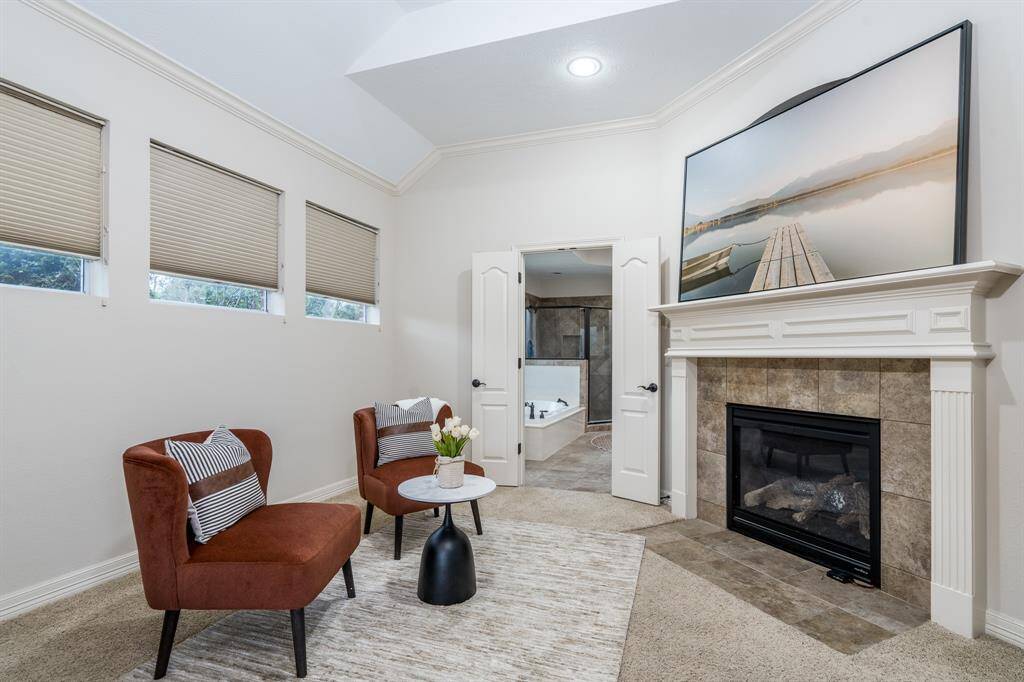 The main-floor primary suite is a private retreat with a sitting area and backyard access.