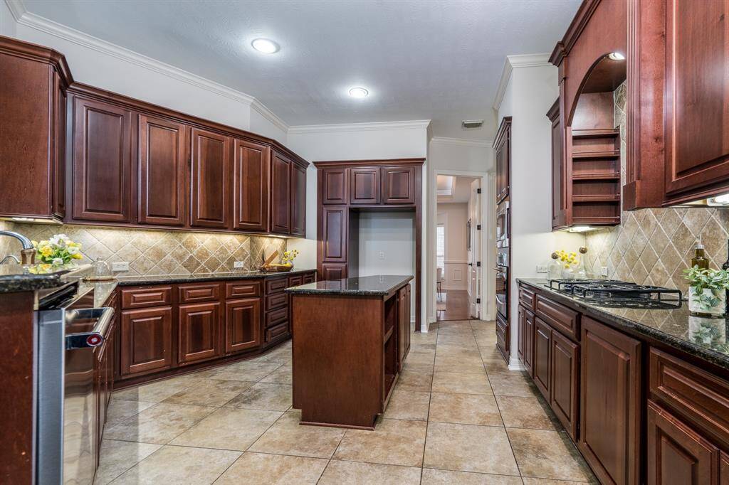A spa-like ensuite bathroom with dual vanities, a soaking tub, a separate shower, and an expansive walk-in closet with full closet system.