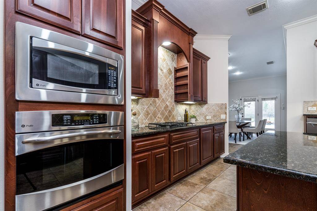 The gourmet kitchen is a chef’s dream, featuring modern appliances, ample cabinetry, and a large center island—perfect for meal prep and gathering with family.