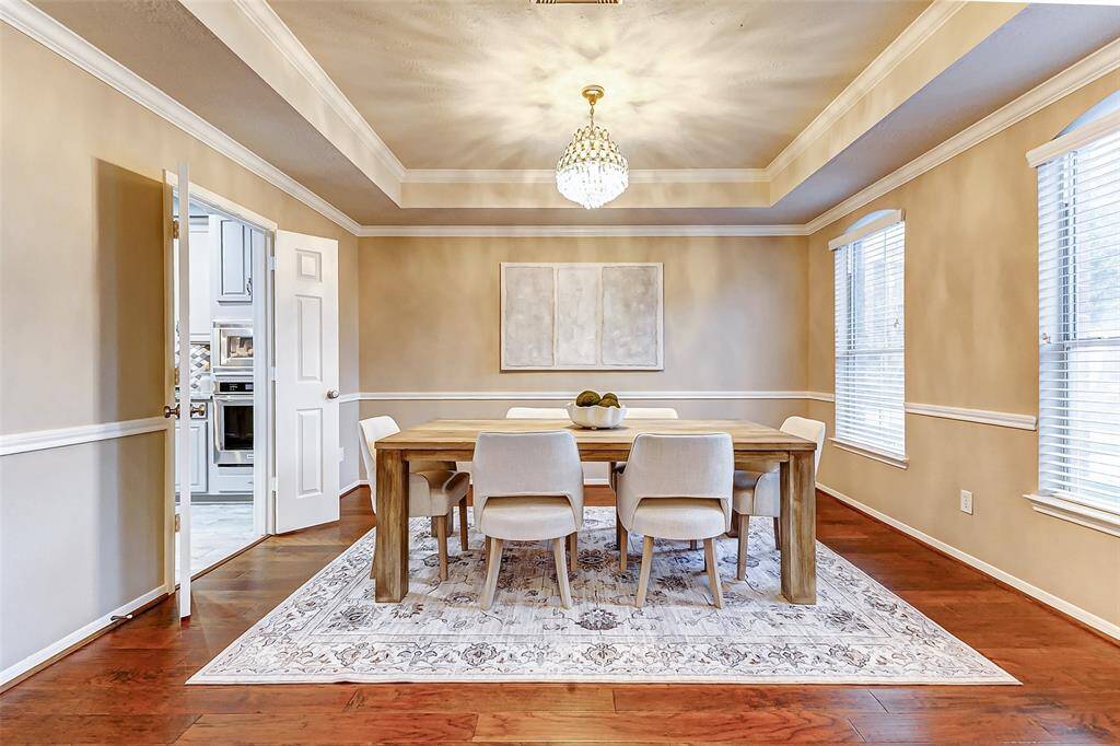 The spacious, light-filled dining room is conveniently located off the kitchen, perfect for entertaining or family meals.