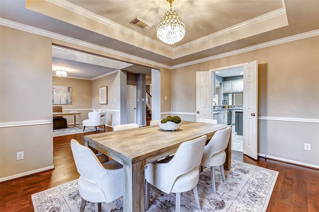 The dining room, conveniently located off the kitchen, features an upgraded chandelier, adding elegance and style to the space.