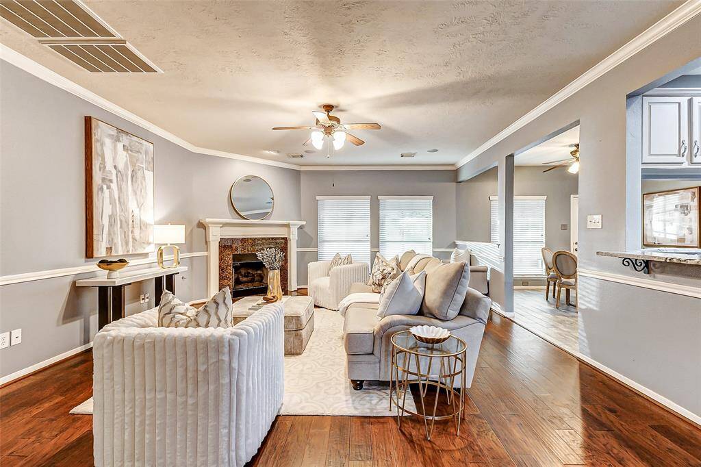 The family room is open to the breakfast area and kitchen, offering easy access to the back patio for seamless indoor-outdoor living.