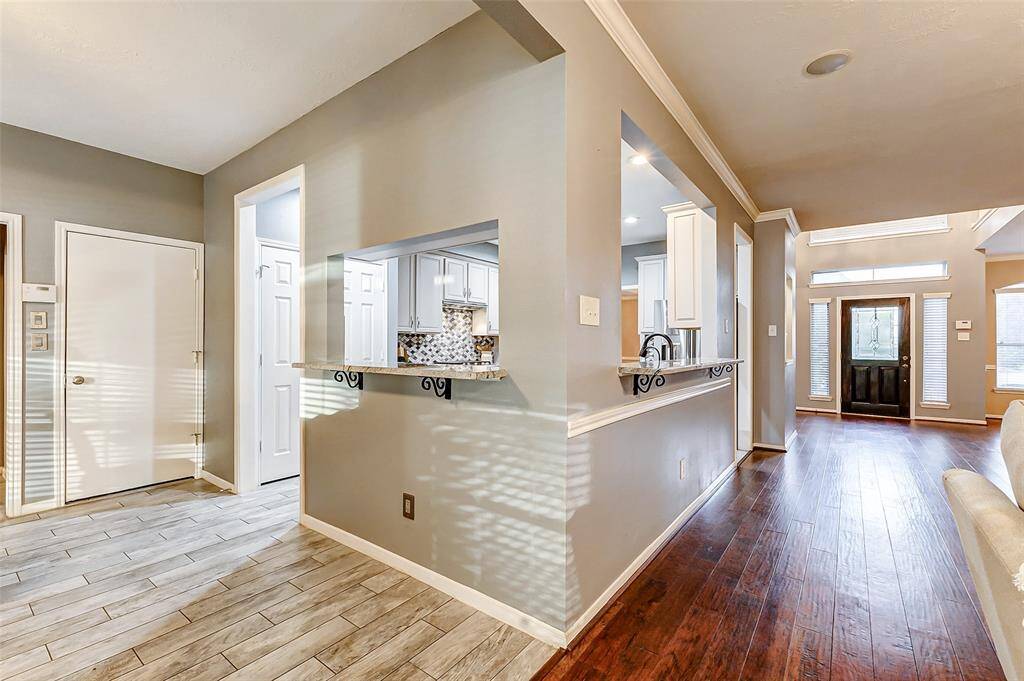Two decorative granite breakfast bars seamlessly connect the kitchen to the family room and breakfast area, creating an open and inviting flow.