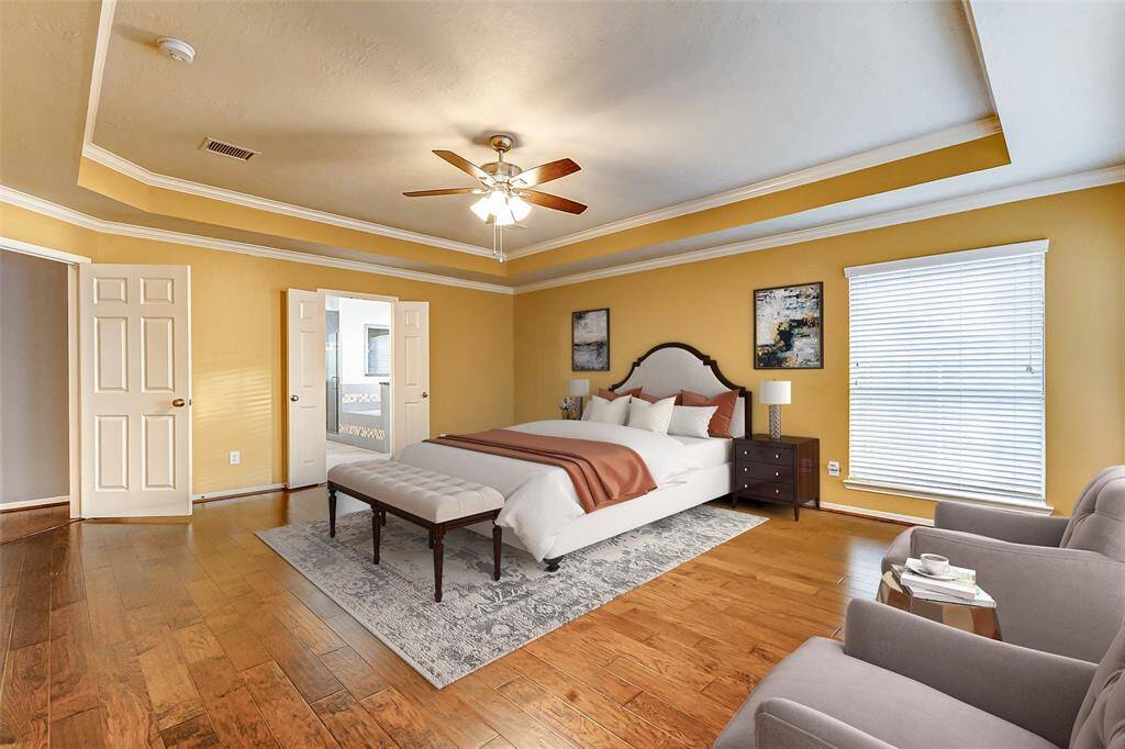 The spacious primary bedroom offers plenty of room for a king-sized bed and oversized furniture. Double doors lead into a luxurious and expansive bathroom.*virtually stagedThe expansive 15x21 primary bedroom boasts a stunning wall of windows that provide a picturesque view of the resort-style backyard, creating a tranquil retreat filled with natural light