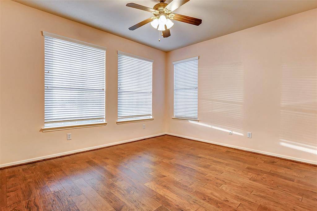 The spacious secondary bedroom downstairs is conveniently located near a full bath, just outside the room for easy access.