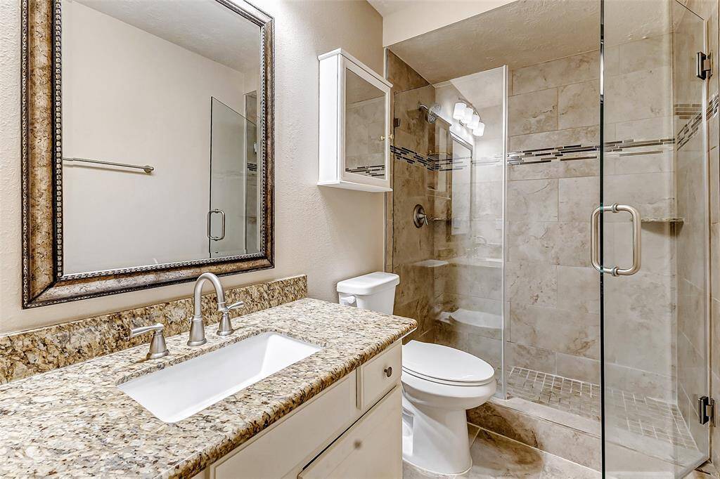 This updated secondary bathroom 3 with walk-in shower is conveniently located off the game room and near secondary bedrooms 3 and 4.