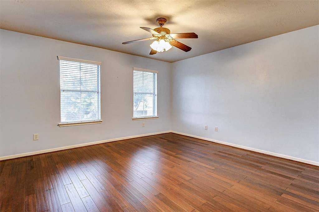 This spacious 14x14 6th bedroom offers a lighted ceiling fan and oversized closet.