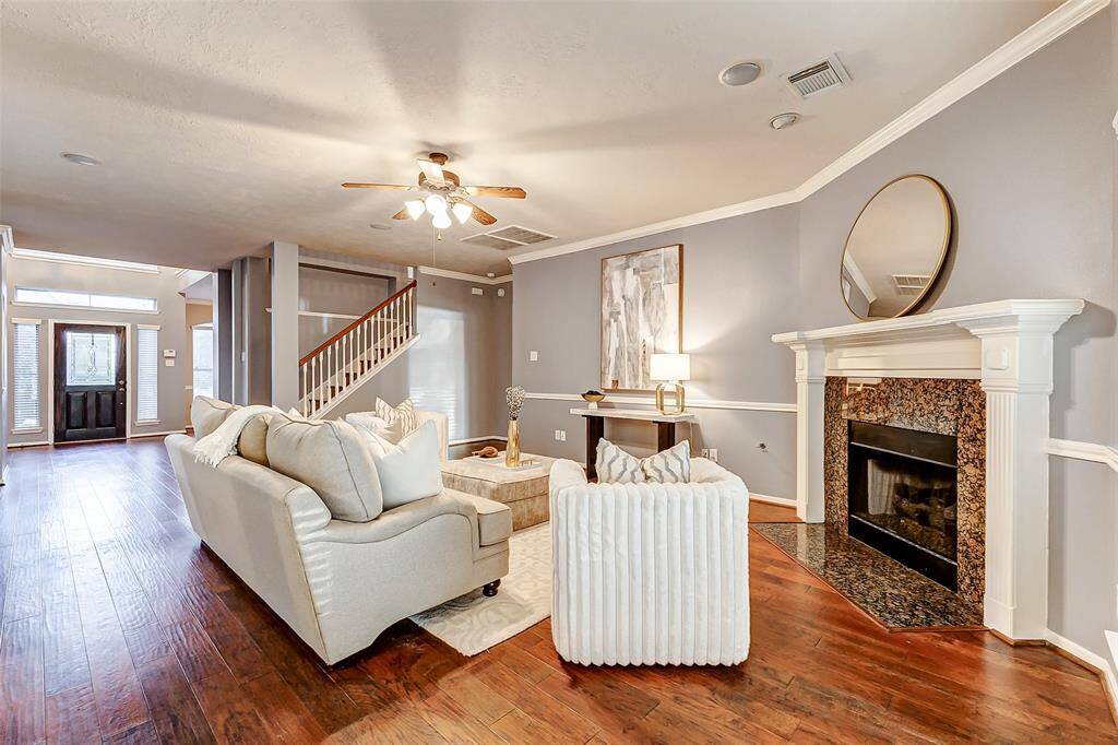 Open to the kitchen, the family room boasts rich wood floors, a cozy corner gas log fireplace, and built-in speakers for immersive surround sound. A stunning wall of windows offers beautiful views of the sparkling pool and spa.