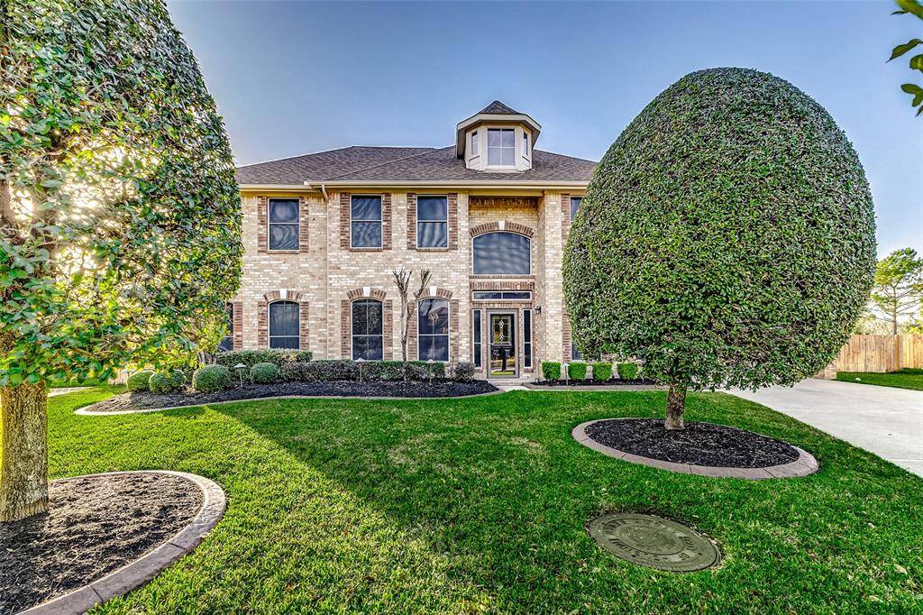 With outstanding curb appeal, this home features meticulously maintained landscaping, a striking brick exterior, and solar screens for energy efficiency...all set on a half/rounded cul-de-sac lot.