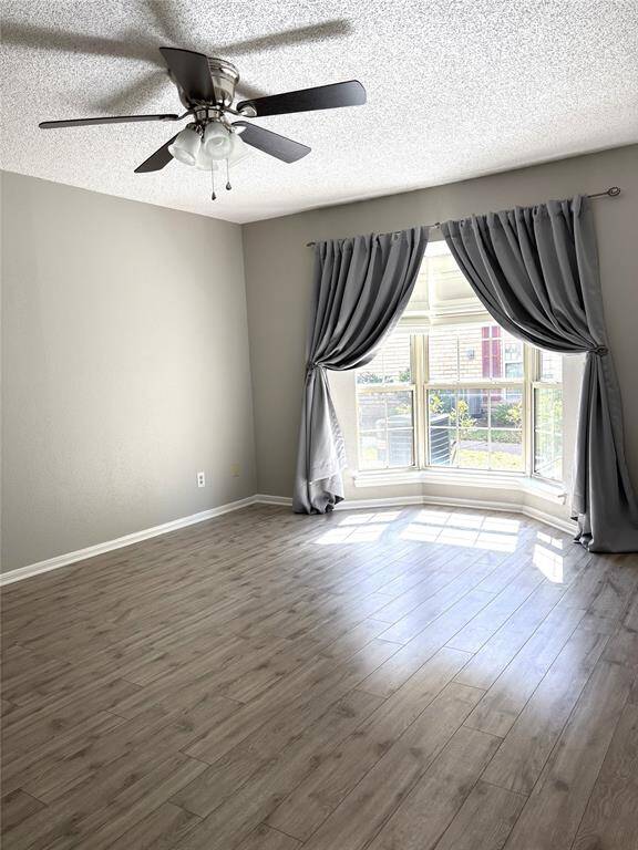 Spacious primary bedroom with bay window and drapery.  Lots of natural light and the double pane windows help lower your electricity bill.  Fresh paint.