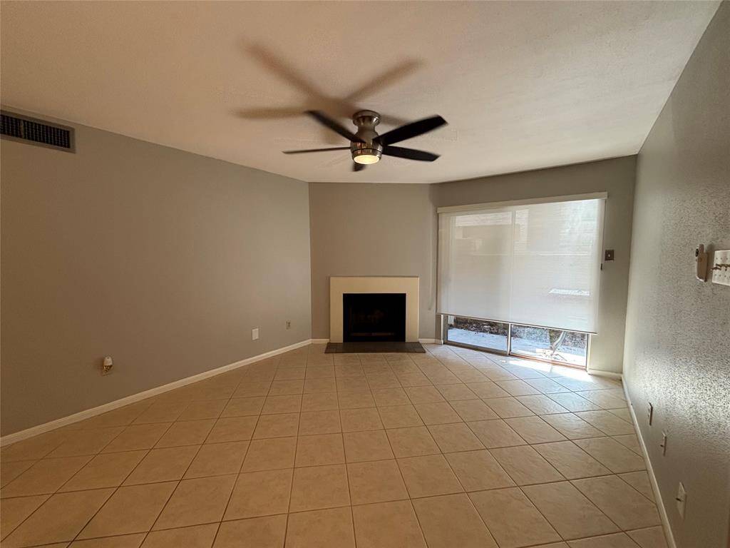 Contemporary color and fresh paint. The bright and airy living room with sliding door is opened to the cozy patio.