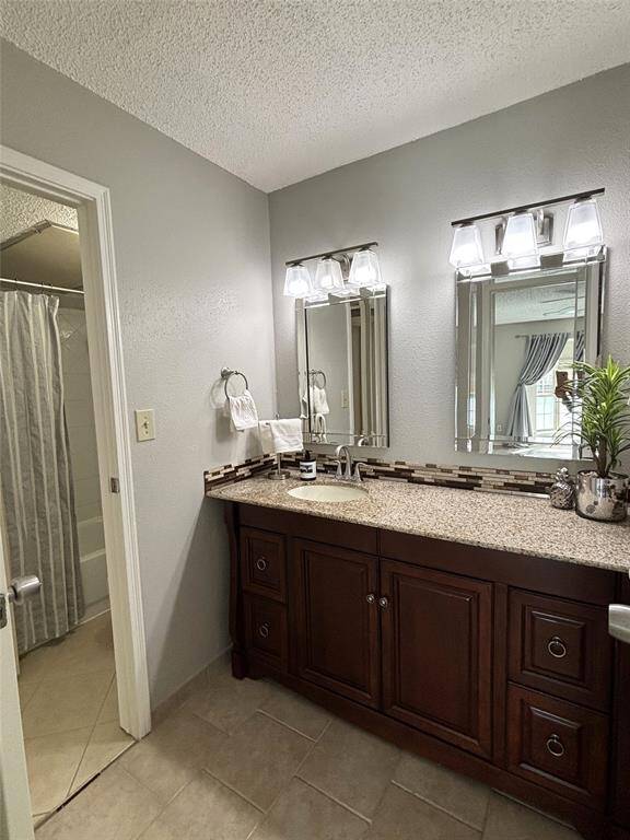 Updated bathroom with beautiful cabinet, backsplash, lighting and granite countertop.