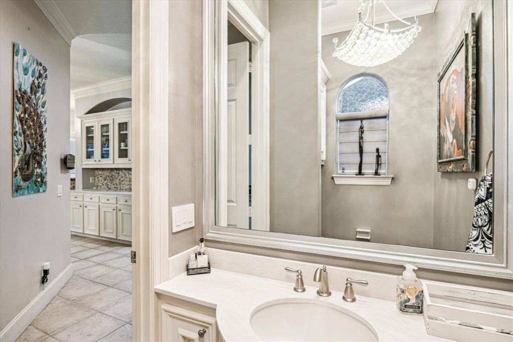 The custom half bath in this luxury home features exquisite finishes and bespoke fixtures, offering a perfect blend of elegance and functionality for guests.