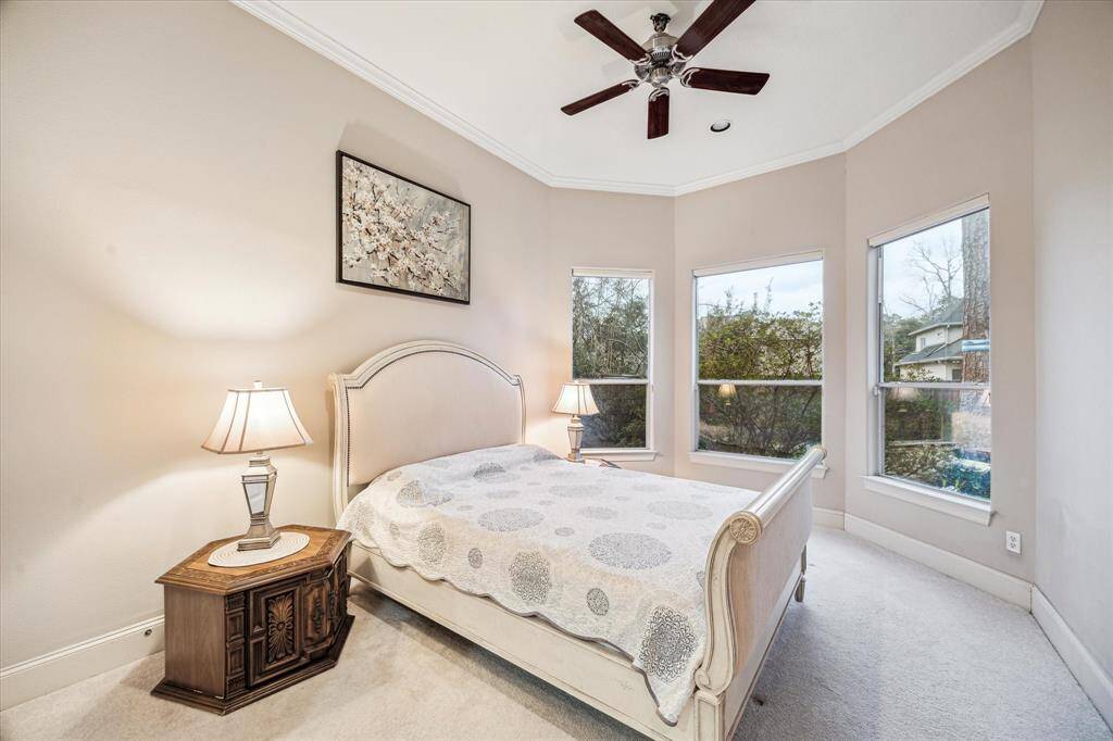 Find serenity in the secondary bedroom, where a creamy palette and warm light create a tranquil retreat.