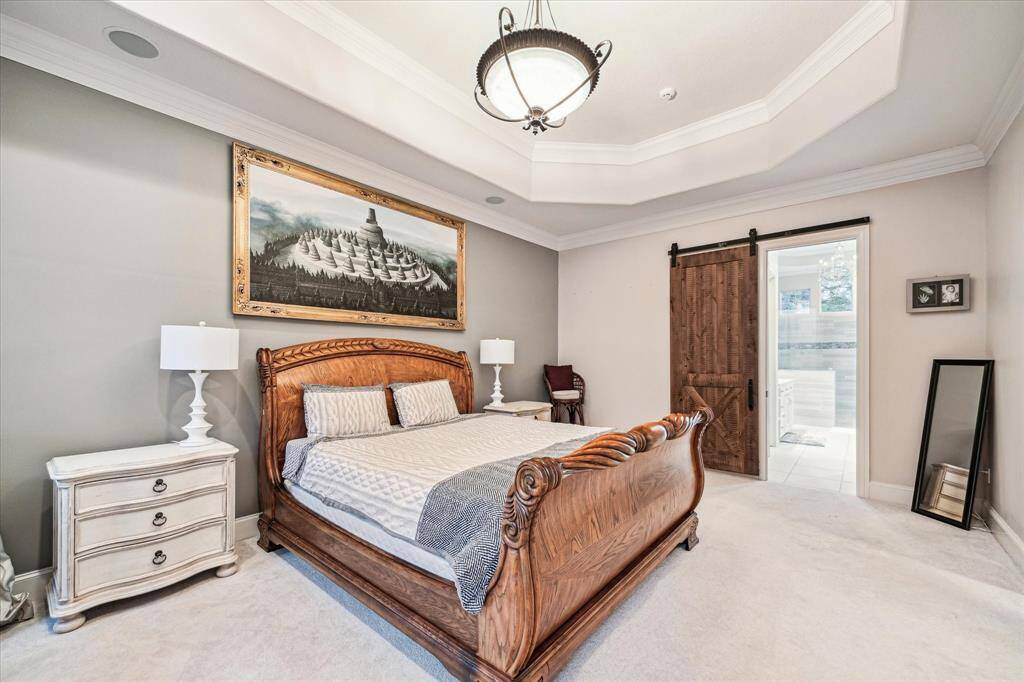 The luxurious primary bedroom, adorned in soothing neutral colors, offers a serene and sophisticated retreat, perfect for unwinding after a long day.