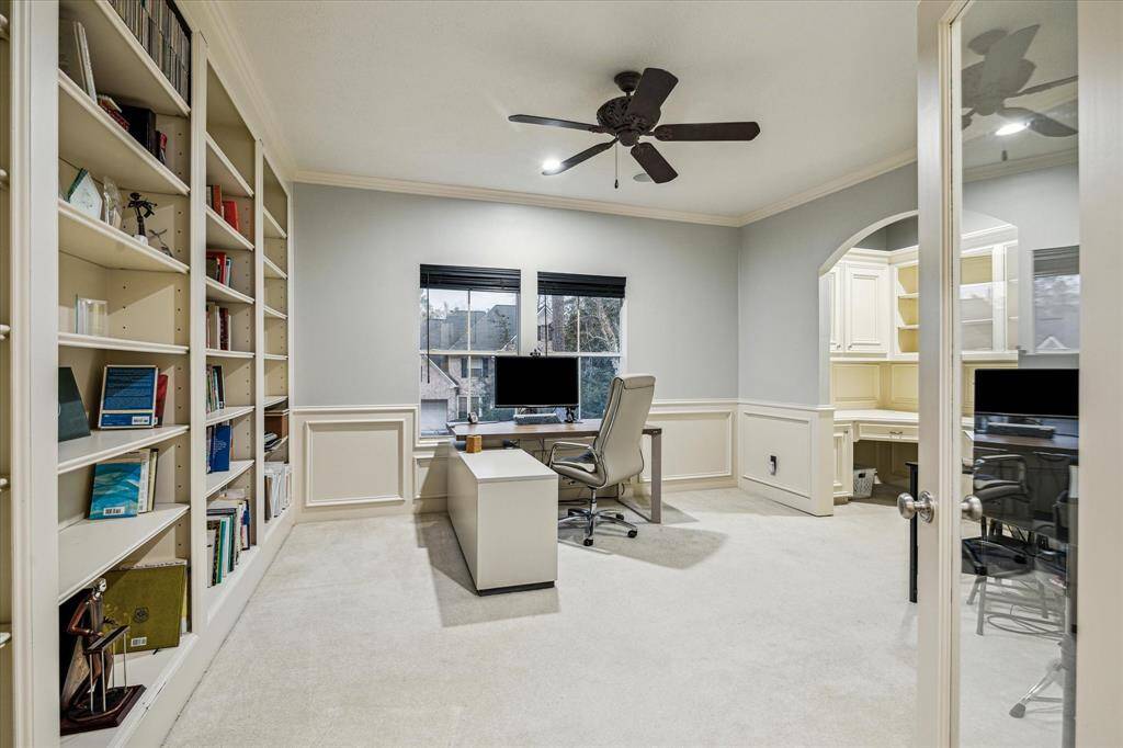 The office with custom built-in shelves makes working from home a breeze.