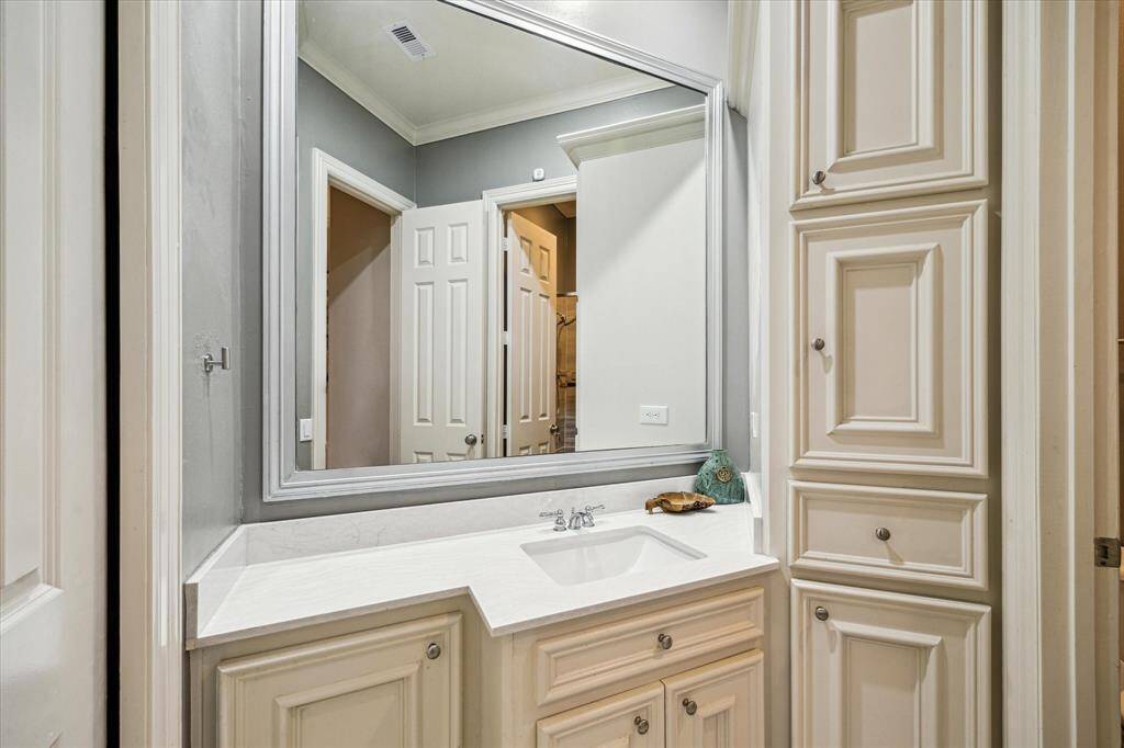 A guest bathroom has lots of cabinets to store linens for visitors.