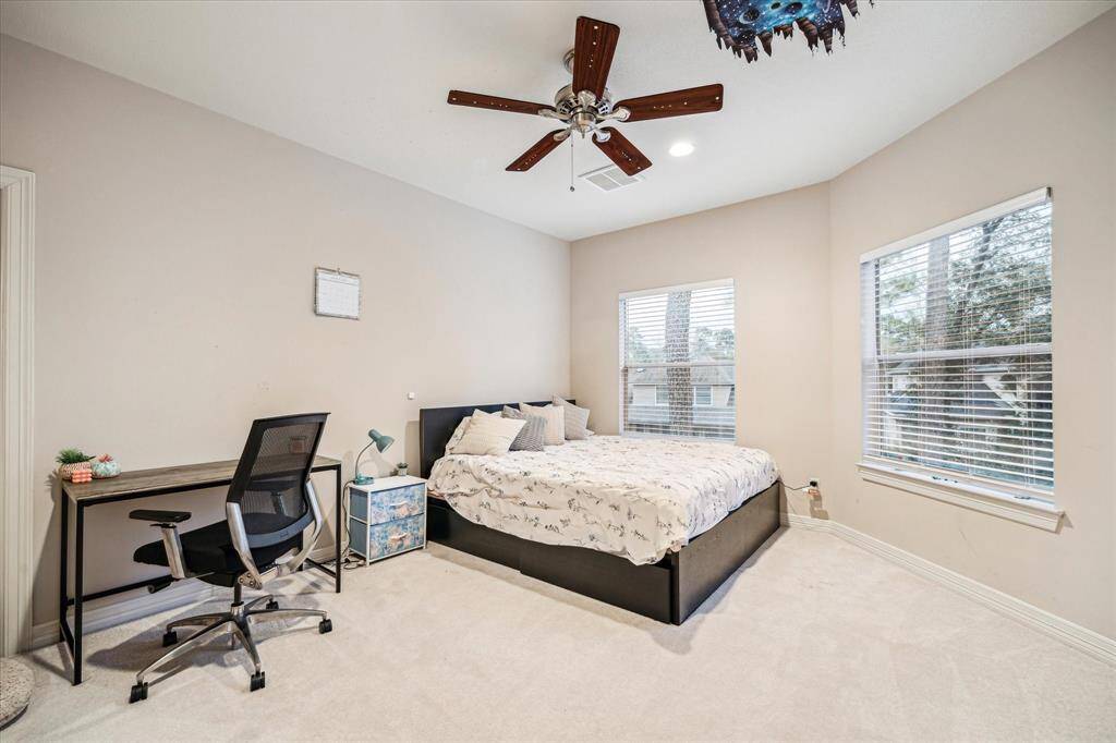 Guests may never leave this welcoming bedroom with views of the backyard.
