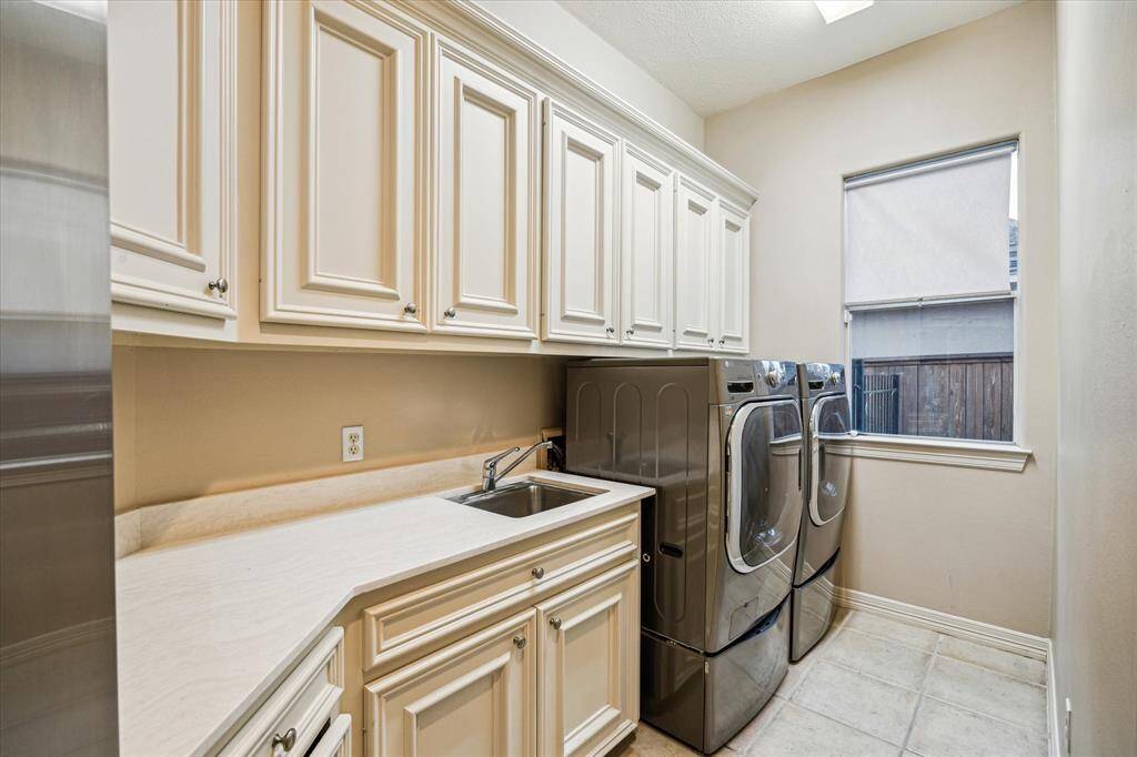 This laundry room is the organizers dream with custom built-in cabinets.