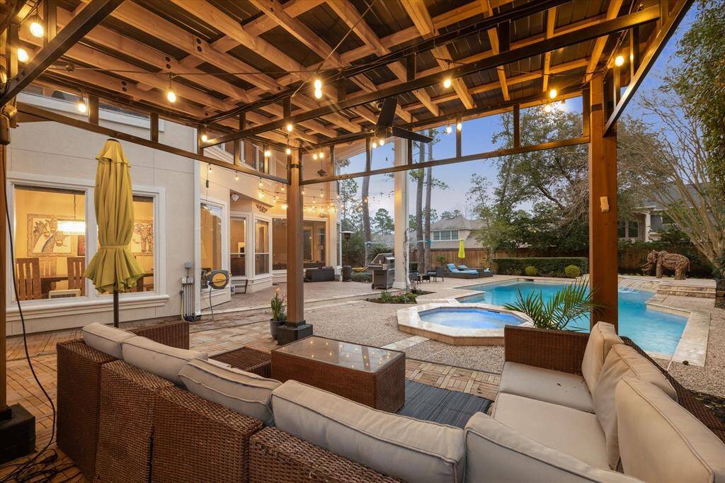 Escape hot Texas summer days under the covered porch or lovely cabana with views of the pool.
