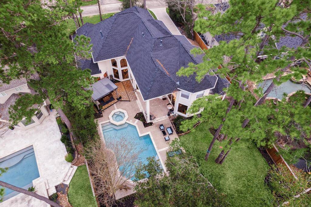 Both palm trees and pine trees decorate this beautifully-maintained yard.