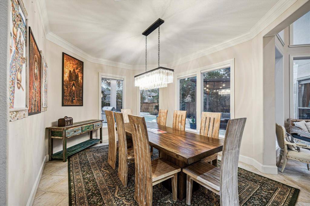 The formal dining area with large windows reach into the backyard space offering an refined entertainment space.