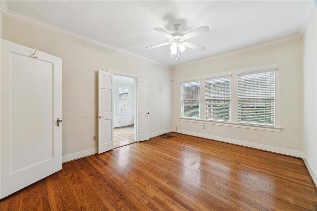 Primary bedroom with plenty of windows and an adjacent office that leads to the backyard greenspace.